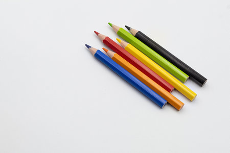 Group of vibrant colored pencils on a clean white surface, representing art, creativity, and educationの写真素材