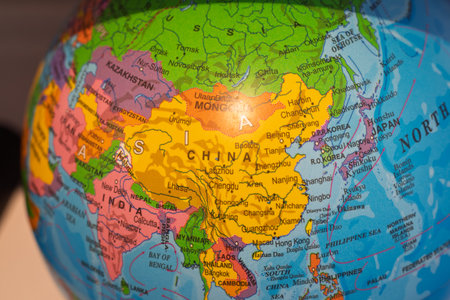 Globe displaying asian countries and cities, highlighting china. Concept of world geography, travel, education, and global businessの写真素材