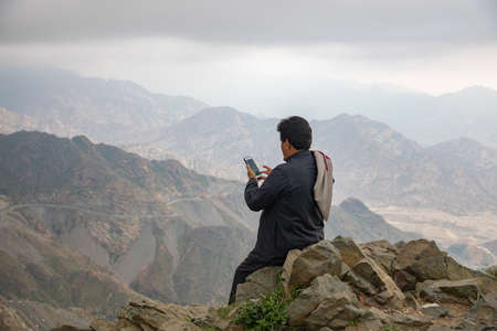 Saudi man watching the beauty of nature in the mountains of Al-Hada Taif, Saudi Arabia 2019のeditorial素材
