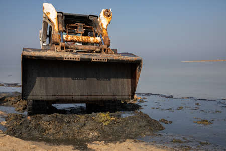 bobcat, works to clean the beach, Skid loader