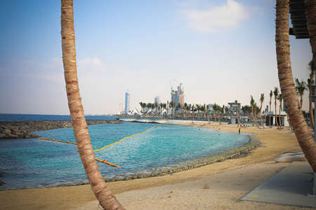 New Corniche in Jeddah from the angle between two palms, sea, swimming place and high towers Saudi...