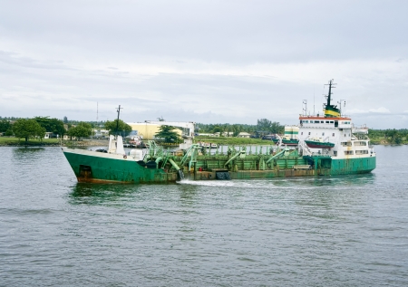 old green dredge in lagos harbourの写真素材