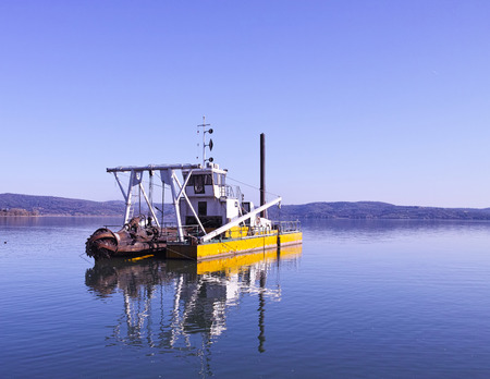 yellow dredging boat on trasimeno lake