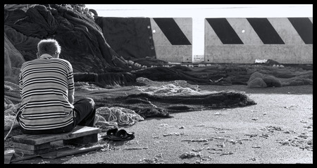 detail of a man that repair fishing netの写真素材