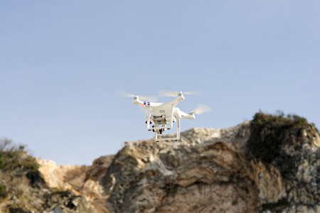 one drone flying against a blue skyの写真素材