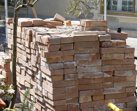 stock of red brick ready for use during the construction of a house