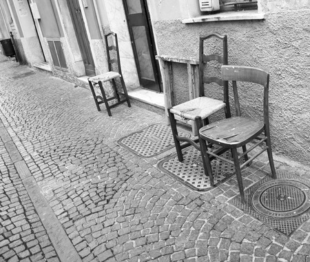 Vintage old black wooden chair in exterio in a streetの写真素材