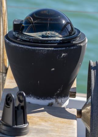 detail of old magnetic compass on a boatの写真素材