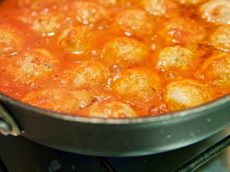 meat balls with tomatoe sauce in a potの写真素材