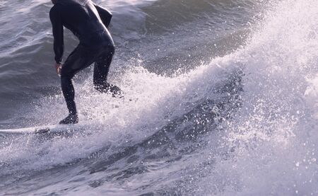 a surfer surf a wave in italyの写真素材