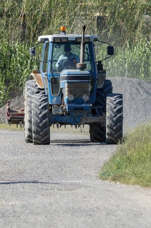 old agricolture tractor during work in a meadow