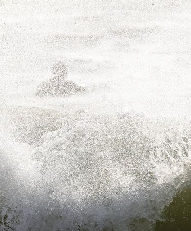 a surfer surf a wave in italyの写真素材