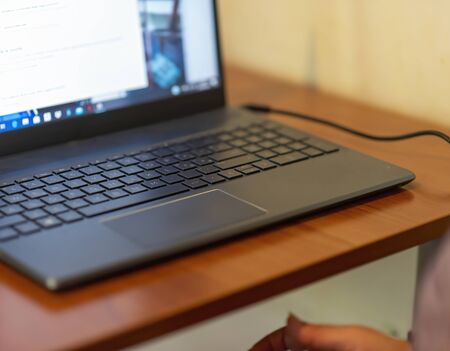 Woman in smart working in front of a laptop typing text during online conference. smart working...