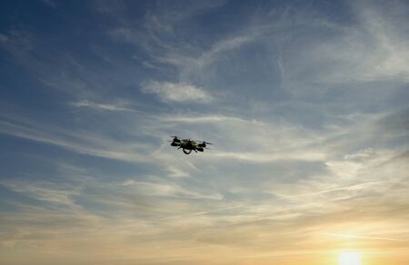 one drone flying against a blue sky in a marble quarry