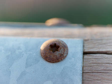 detail of rusty bolt ina wooden benchの写真素材