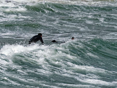 a surfer surf a wave in italyの写真素材