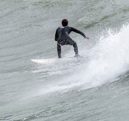 a surfer surf a wave in italyの写真素材