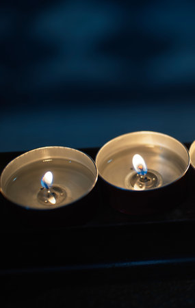 Burning candles isolated on black backgroundの写真素材
