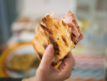 Roman-style pizza alla pala with speck, cherry tomatoes and basil, and artisan focacciaの写真素材