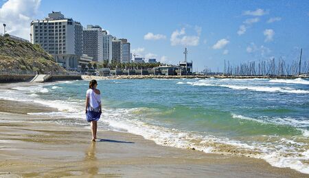 Tel Aviv, Israel, May 19, 2016Girl walking along the seashoreの写真素材