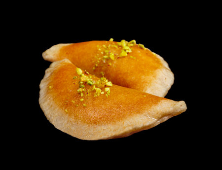 Qatayef, Traditional Arabic Ramadan Sweets with pistachio on black background,side view, close-upの写真素材