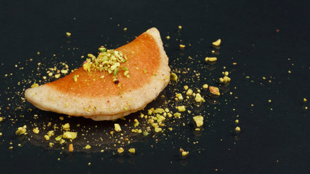 Qatayef, Traditional Arabic Ramadan Sweets with pistachio on black background,side viewの写真素材