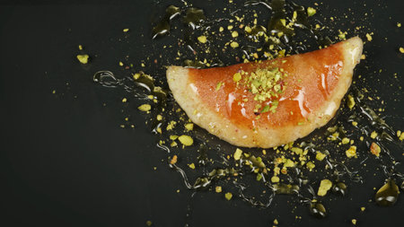 Qatayef, Traditional Arabic Ramadan Sweets with pistachio and honey on black background,top viewの写真素材