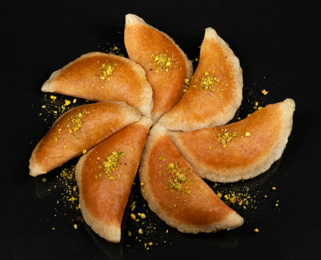 Qatayef, Traditional Arabic Ramadan Sweets with pistachio on black background,top viewの写真素材