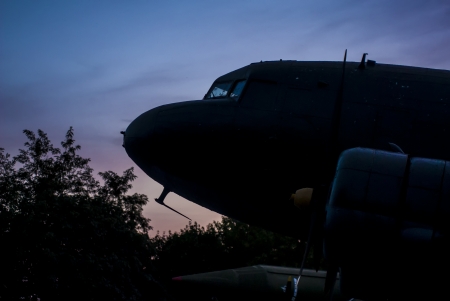 Ancient military airplane silhouette in the sunsetの写真素材