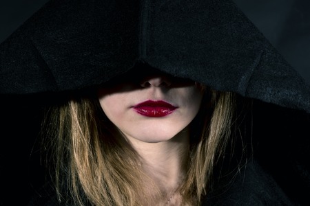 Lips details of a blonde gothic priestess in the darkの写真素材