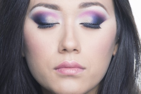 Glamor portrait of a beautiful brunette with colored eyes and light lipstickの写真素材