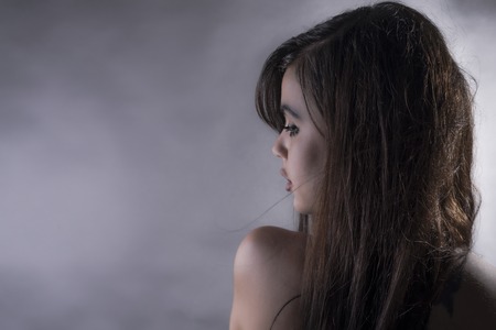 Side view glamour woman portrait over grey backgroundの写真素材