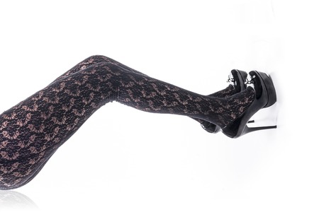 Isolated sexy legs with stockings and shoes over white backgroundの写真素材