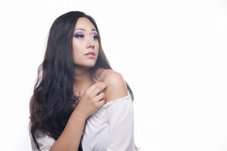 Side portrait of a model with long and black hair isolated over white backgroundの写真素材