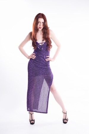 Fashion model with violet dress looking youの写真素材