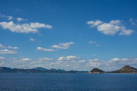 Seaside view of Golfo Aranci coastline in morning light, Sardinia Italyの写真素材