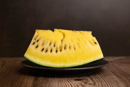 Yellow watermelon on black plate, think different