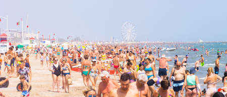 Beach with bathers in summer. Rimini, Italy, editorial image