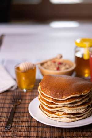 Pancake breakfast with honey and granola. High quality photo