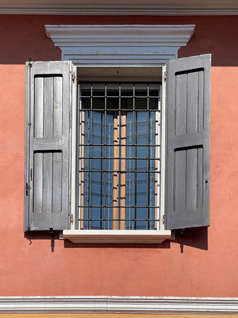 Traditional window of Italian buildigns with closing doors in wood