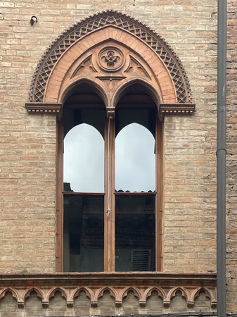 Medieval window of Italian buildigns with closing doors in wood
