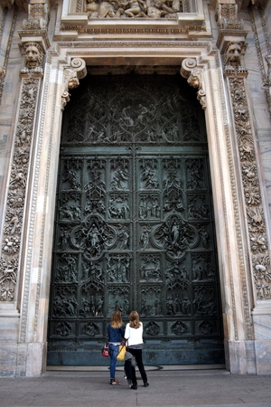 Mother and daughter in front of the Milan cathedral door, Italyのeditorial素材