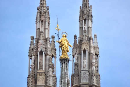 golden statue of the Virgin Mary on top of Milan Cathedral, Italyのeditorial素材