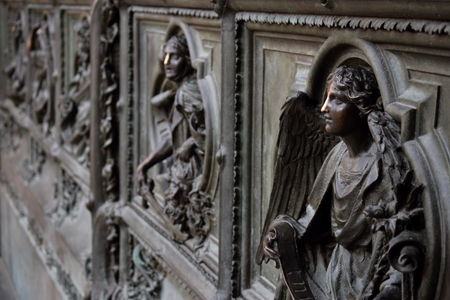 images of saints at the door of the cathedral in Milan, Italy
