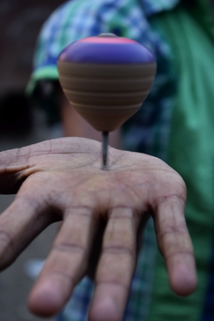spinning top in the hand of a child in Chittagong, Bangladesh