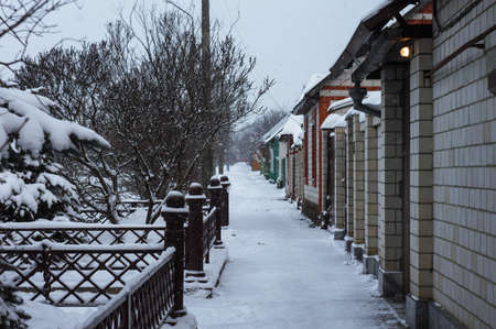 Winter snow-covered Russian street, private sectorの写真素材