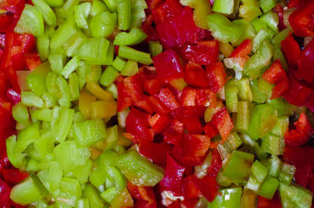 Red and green paprika cut into small piecesの写真素材