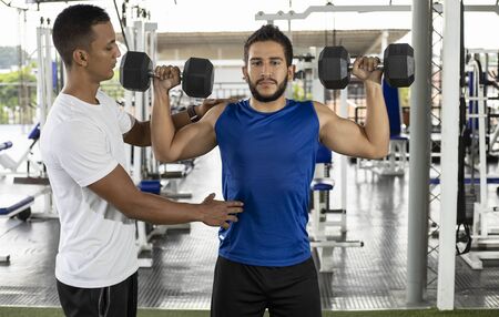 gym trainer teaching weight training