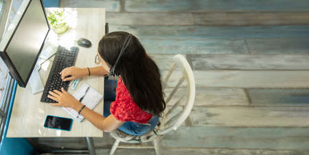 zenith view of work site of latina girl working from home