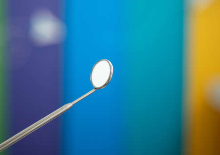 Dental instrument, mirror on colored backgroundの写真素材